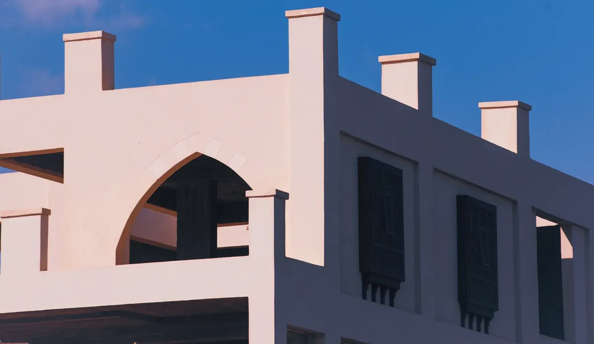 A modern building with unique architectural design under a clear blue sky.