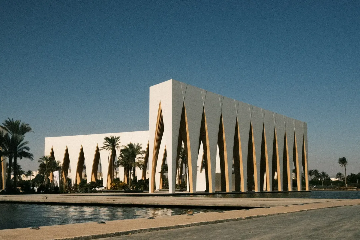 Captivating view of a modern architectural landmark at El Gouna Festival Plaza, surrounded by palm trees.